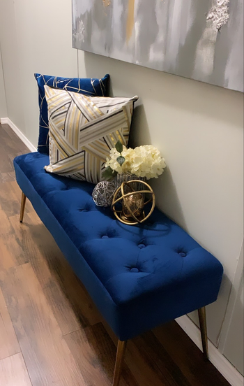 blue tufted bench in an entryway