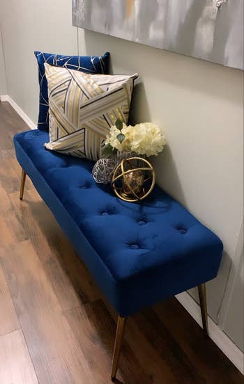 blue tufted bench in an entryway