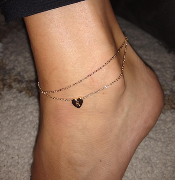 Reviewer wearing the initial anklet with an 