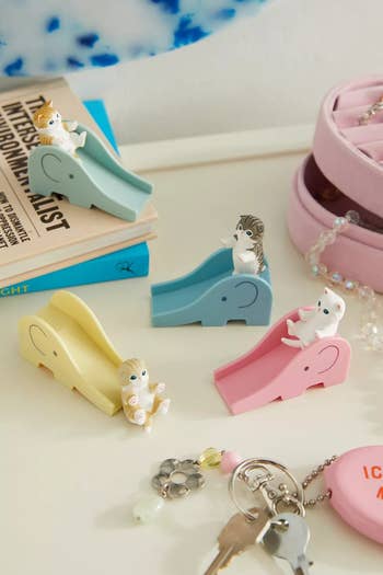 cat figurines on small colorful slides