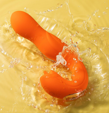 Orange dual-stimulating vibrator in water