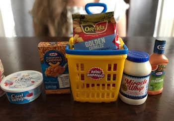 reviewer's mini toys — Cool Whip, Miracle Whip, salad dressing, french fries, and Kraft mac and cheese