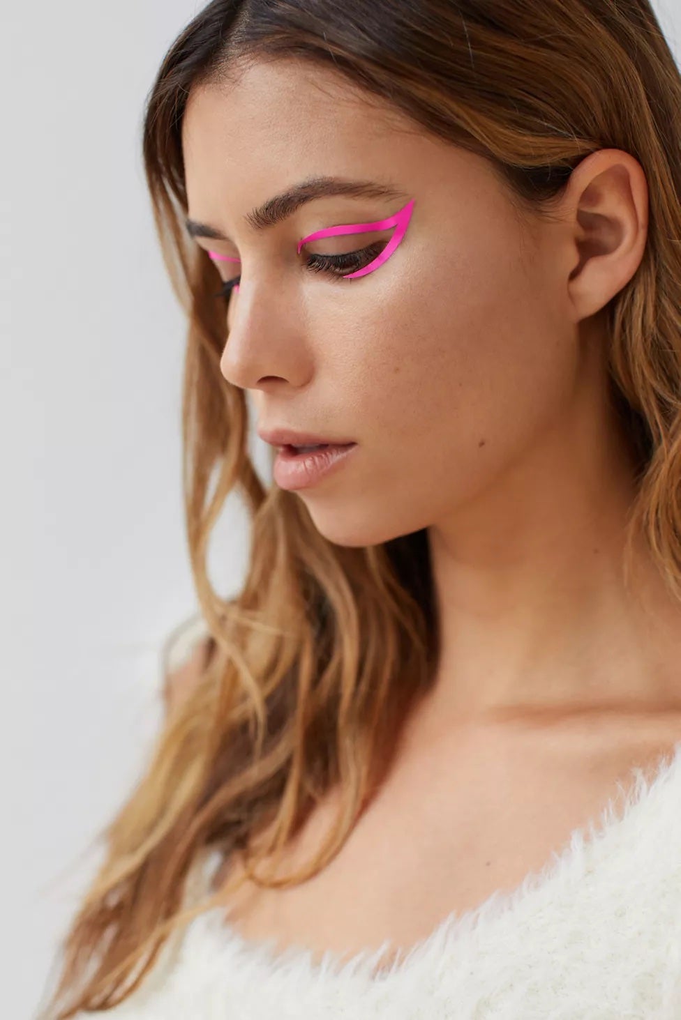 model wearing hot pink exaggerated cat eye sticker