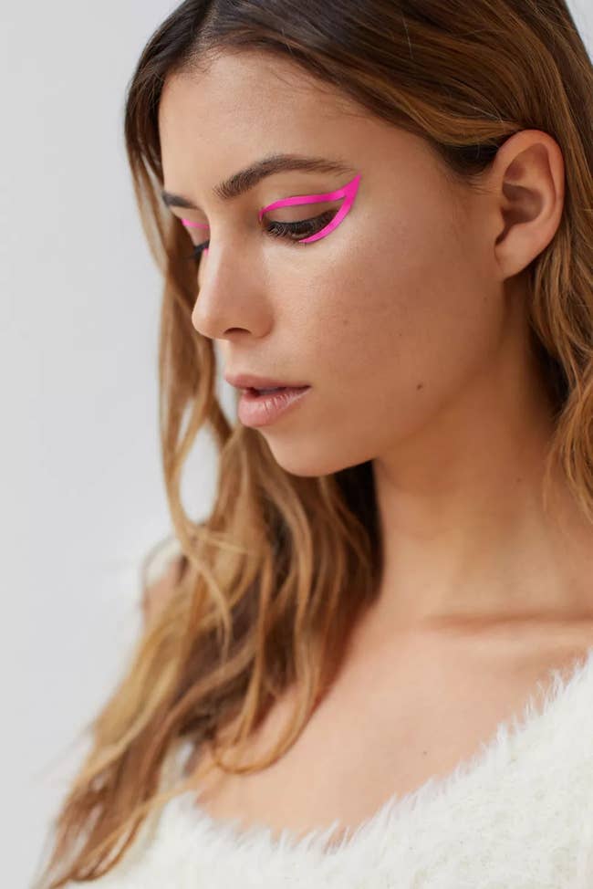model wearing hot pink exaggerated cat eye sticker