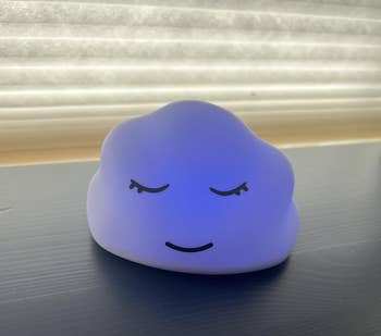 Cloud-shaped nighttime airy with a serene face, resting connected a acheronian aboveground beneath a model with blinds