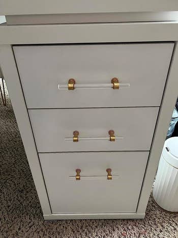 after of the same cabinet with acrylic and gold drawer pulls