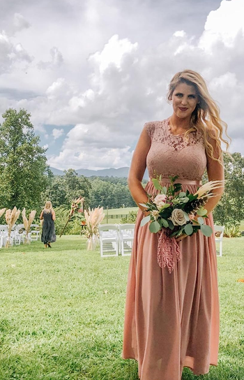 different reviewer wearing the same long pink dress as a bridesmaid