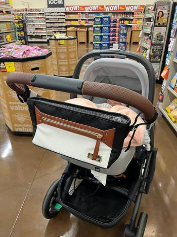 A stylish baby stroller with a designer diaper bag in a shopping aisle