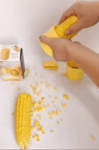 Model using yellow circular device to peel corn off the cob 