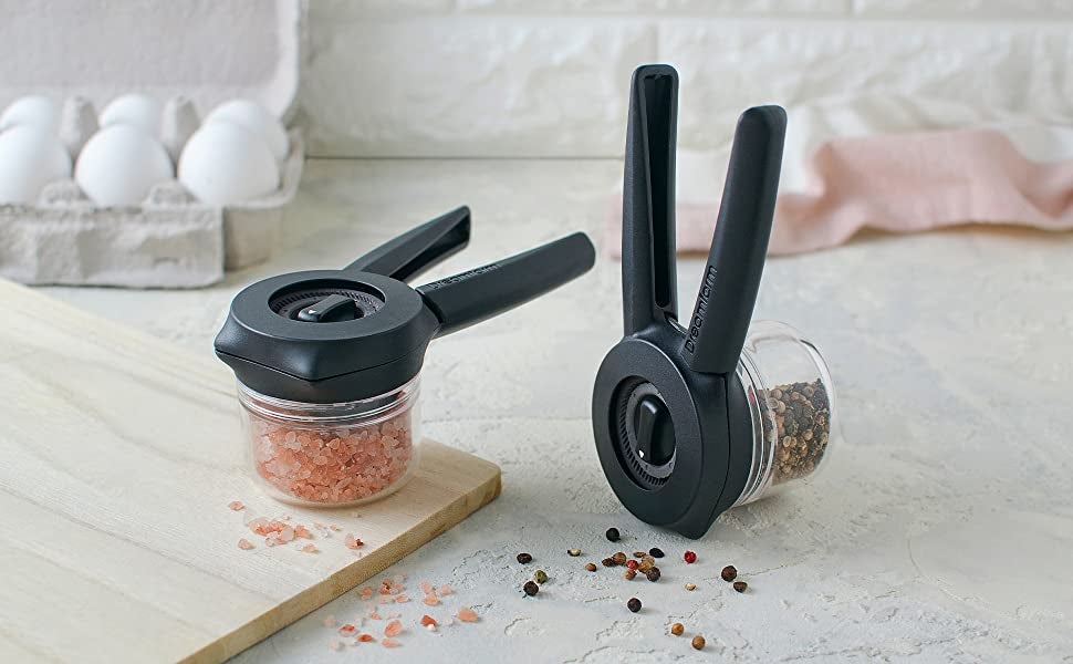 two of the grinders one with salt inside and one with pepper inside