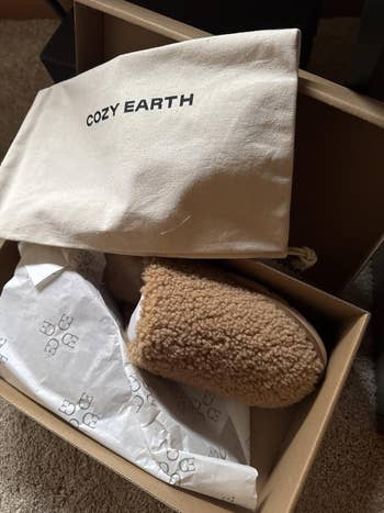 Cozy Earth slippers successful a box, with a branded cloth container included. Ideal for a buying nonfiction featuring comfy location footwear