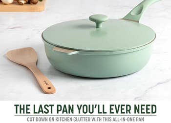 A non-stick sauté pan with a lid and wooden spoon, placed on a kitchen counter with vegetables in the background