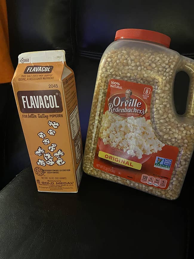reviewer image of a carton of popcorn salt next to a jug of kernels
