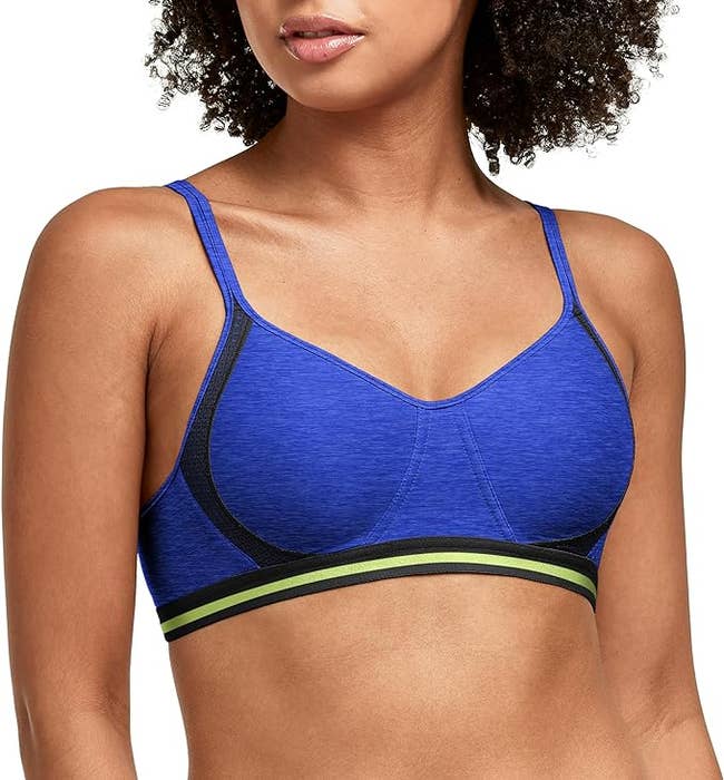 A model wears a stylish sports bra that features mesh panels