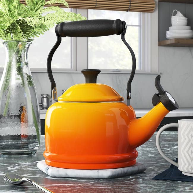 the ombre orange tea kettle with black handle