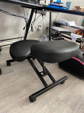 Ergonomic kneeling chair with black cushions in a home office setting