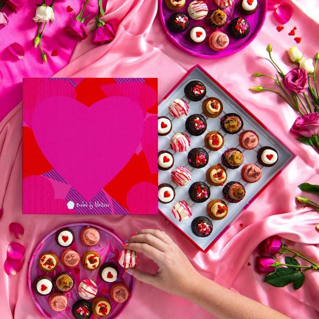 valentine's day-themed mini cupcakes in a box with pink hearts on it 