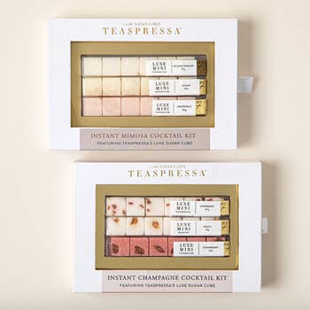 Two Teaspressa instant cocktail kits in packaging, one for mimosas, one for sugar cube cocktails