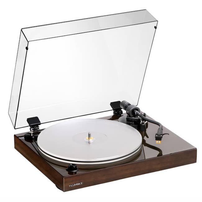 Turntable with a wide particulate screen open, featuring a vinyl grounds connected the platter. Ideal for euphony enthusiasts oregon arsenic a stylish location accessory