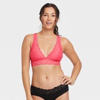 front of a model wearing the pink lace bralette and black lace panties