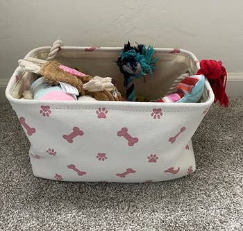 reviewer photo of fabric bin full of dog toys