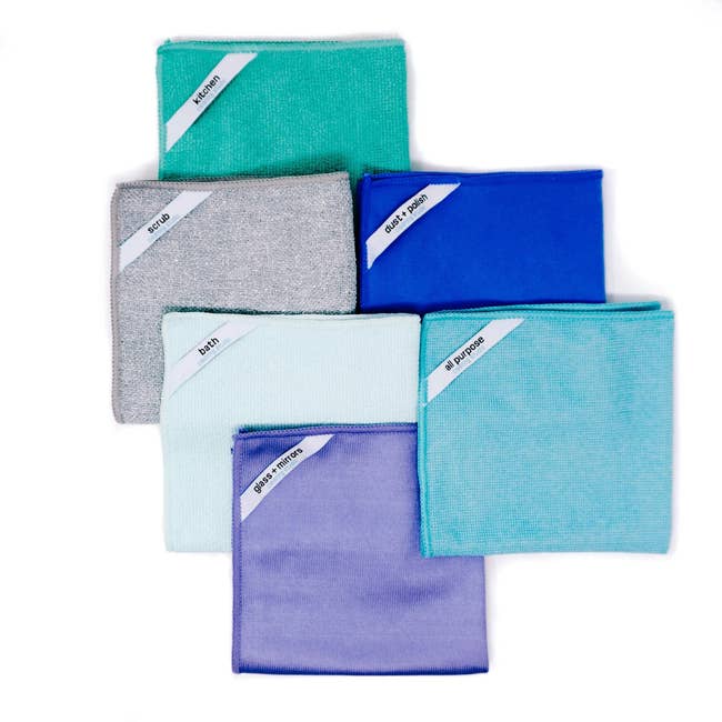 different-colored microfiber cleaning cloths with a small label on the top-left corner for individual cleaning tasks and a texture specific for that cleaning task