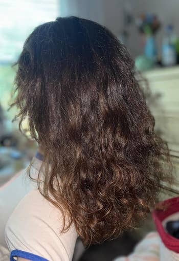Person showcasing wavy, shoulder-length hairsbreadth  with volume, wearing a casual top. Ideal for quality   and haircare buying  content