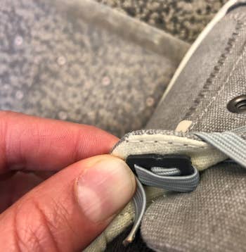 reviewer showing close up of how the elastic shoelaces are secured