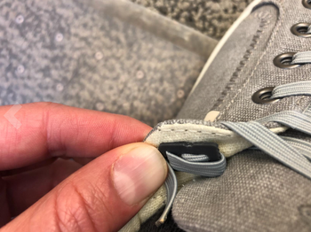 reviewer showing close up of how the elastic shoelaces are secured