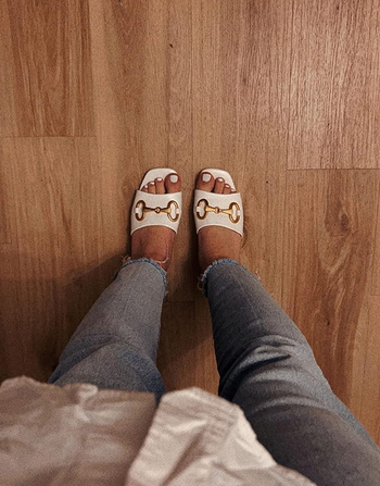 reviewer wearing the heels in white