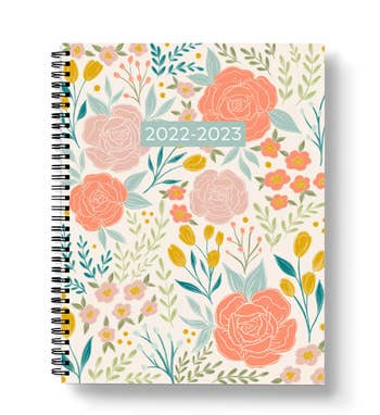 A blue, yellow, orange, and white floral spiral bound planner 