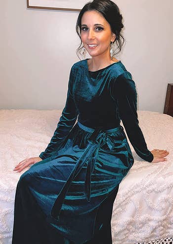 reviewer wearing the dark green velvet dress