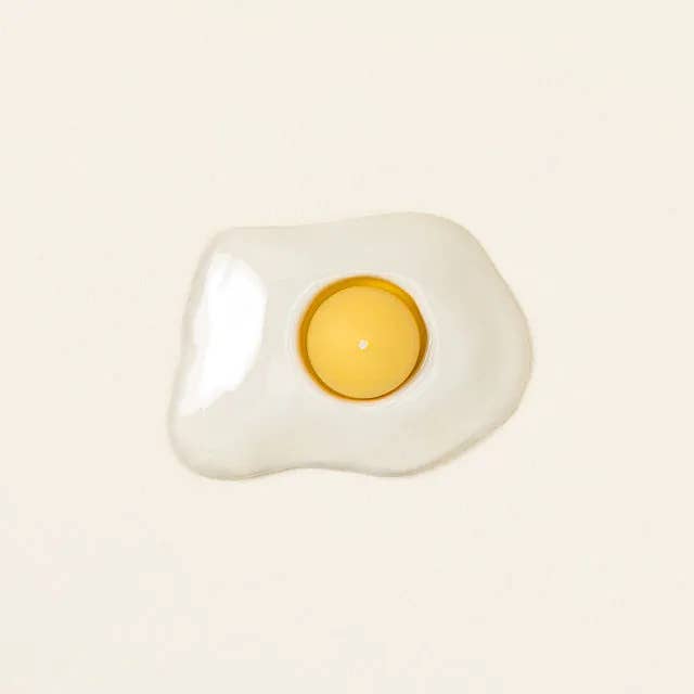 candle older shaped like egg white and candle shaped like yolk