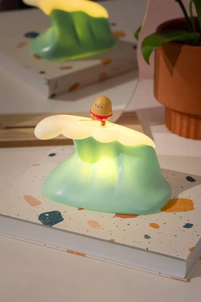 wave lamp with tiny potato surfing on top 