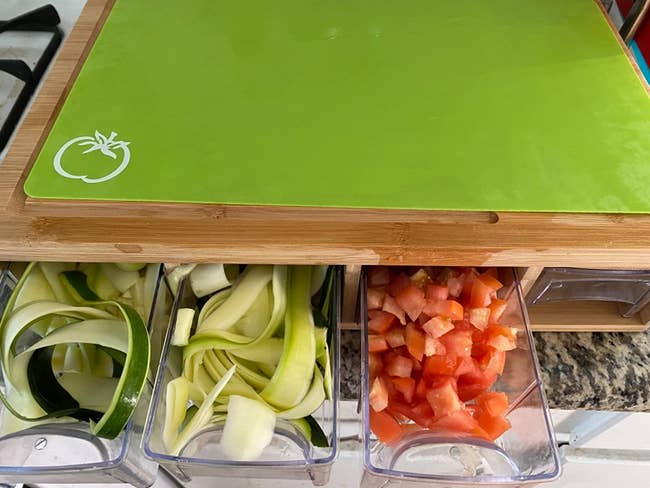 cutting board with pull out containers to be filled with sliced veggies