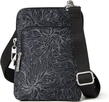 Black crossbody bag with floral pattern, adjustable strap, and brand logo