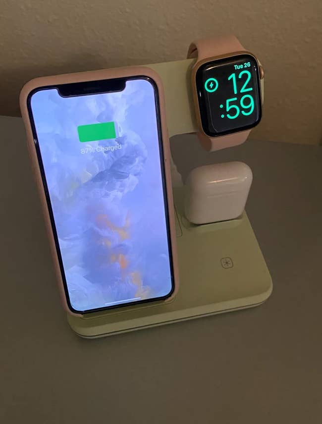 reviewer photo of the standing charging iPhone, Apple Watch, and AirPods