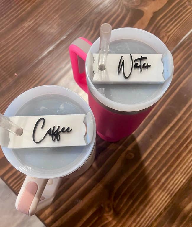 two cups one has a plate that says coffee on top and the other says water