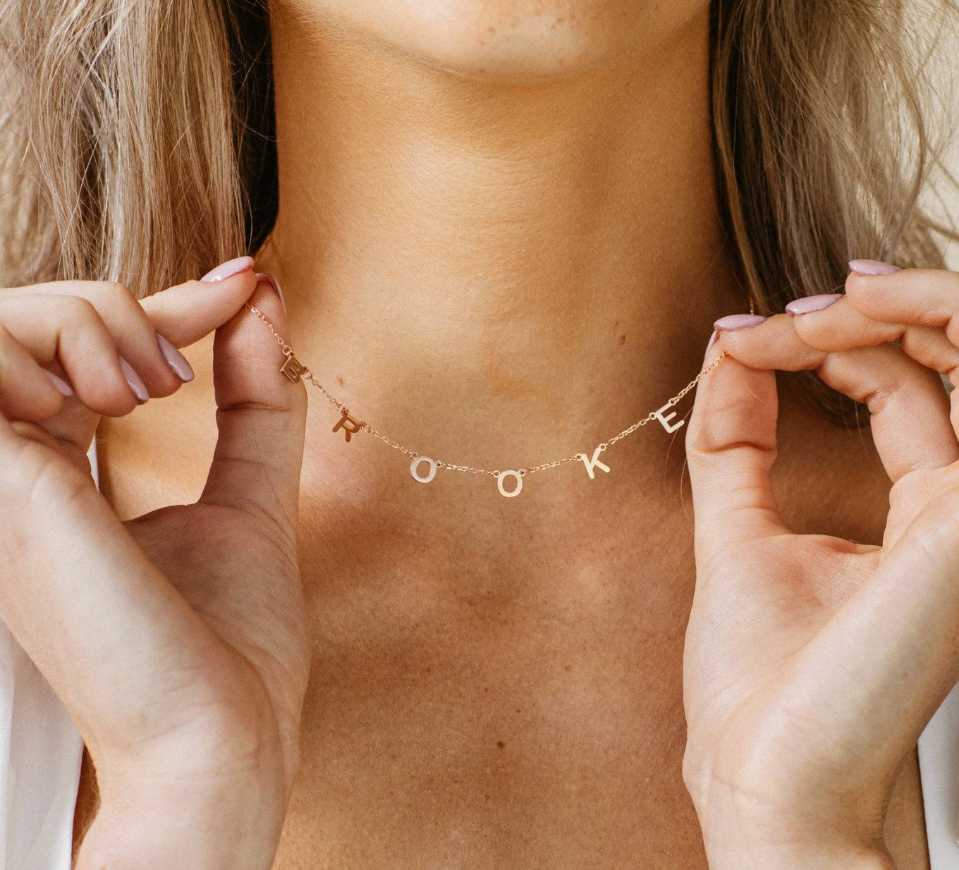 model wearing name necklace that reads brooke