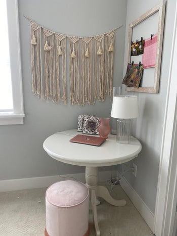 A cozy corner with a macrame wall hanging