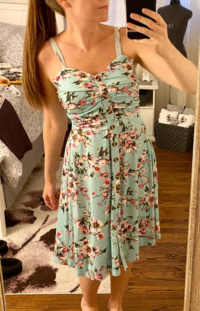 reviewer in the spaghetti strap, button front dress in mint and pink floral