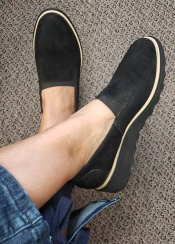 reviewer wearing the black loafers