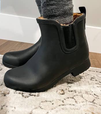 the boots in black on a reviewer's feet