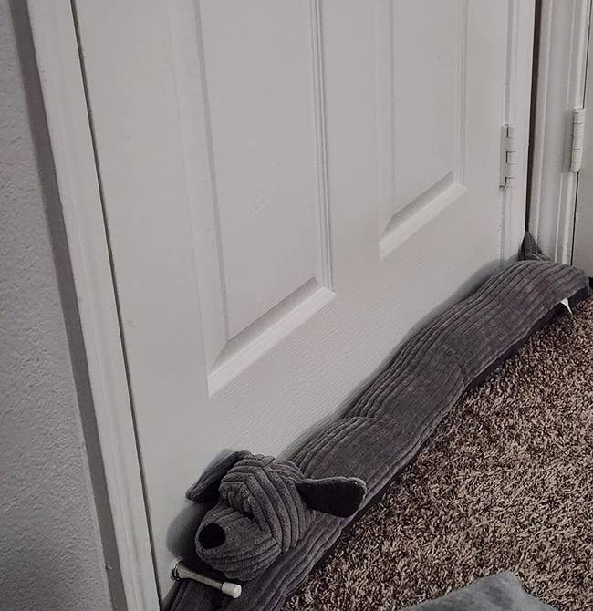 reviewer's weighted door stopper that looks like a gray dog