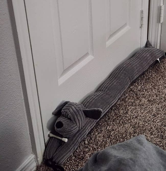 reviewer's weighted door stopper that looks like a gray dog