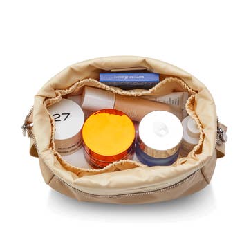 top-down view of makeup products in makeup bag