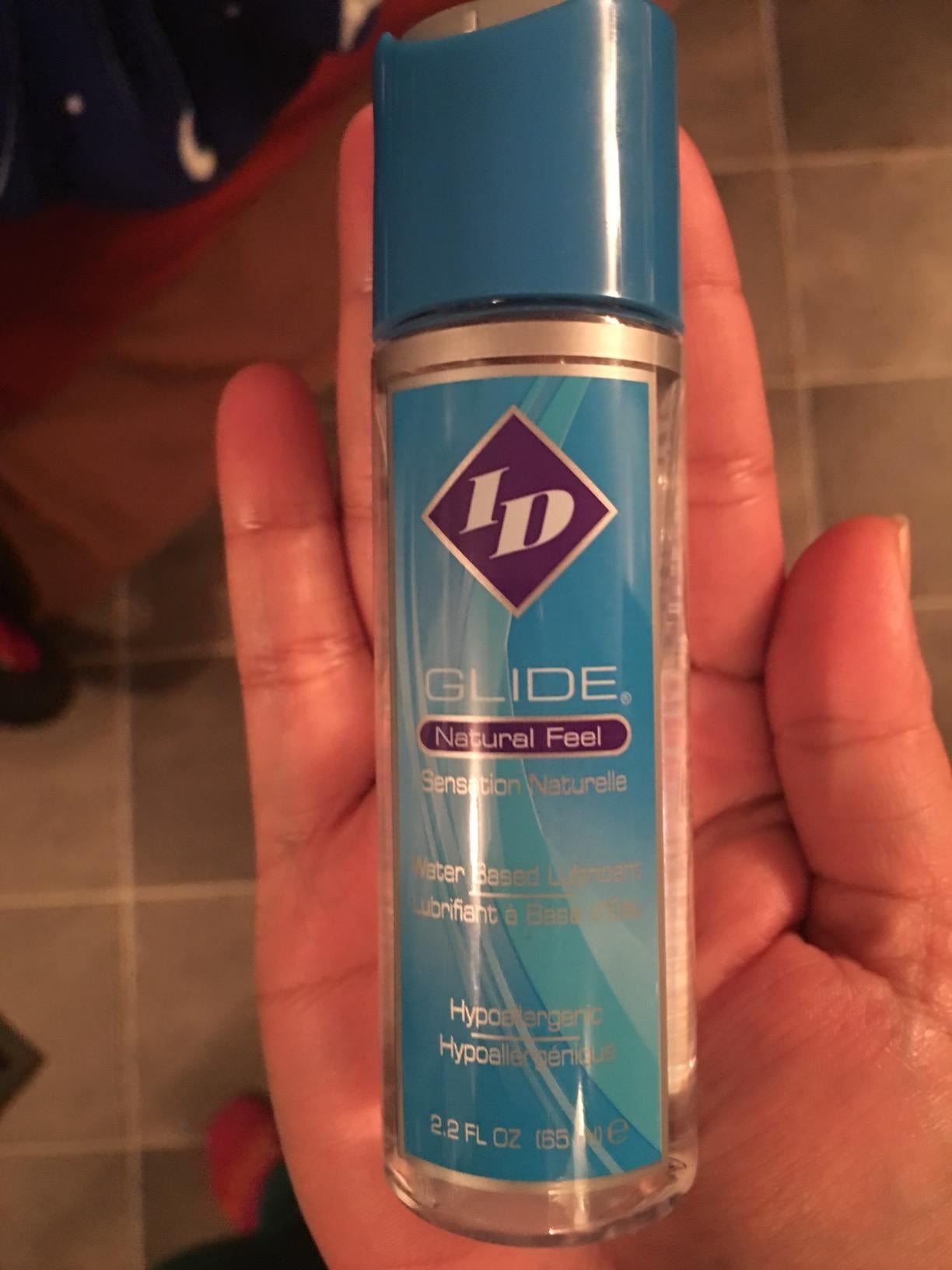Model holding small bottle of ID Glide lubricant