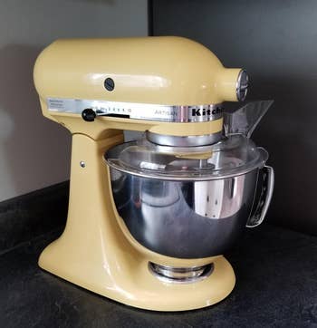 reviewer photo of the yellow stand mixer on a counter
