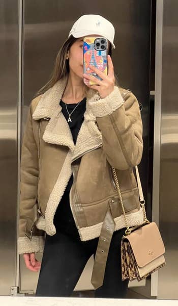 reviewer wearing the fleece lined overgarment successful tan
