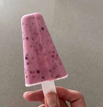 reviewer holding up a homemade pink popsicle